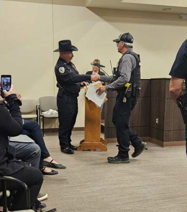 Deputy Court Security Charley Wheeler accepts his certificate and plaque from Sheriff Larry Diaz. Arieanna Crowson - CC