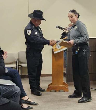 Deputy April Salazar accepts her certificate and plaque from Sheriff Larry Diaz. Arieanna Crowson - CC