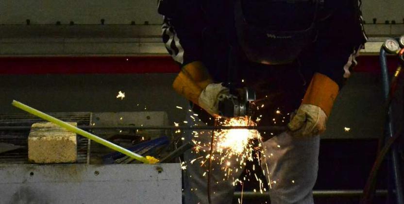 Welding student at LAHSis cutting pieces of metal for the class to use to practice welding together Kathryn Marmon - CC