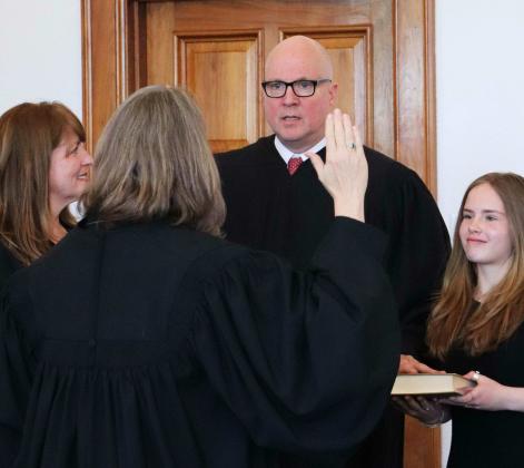 Chief Justice David K. Thomson takes the oath of office, with his wife, Patty, and daughter, Ava, at his side. The oath was administered by outgoing Chief Justice C. Shannon Bacon Photo courtesy of the Administrative Office of Courts