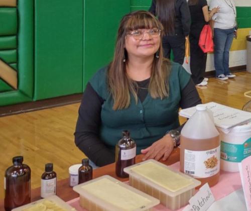 Thoreau HS math teacher and entrepreneur Vanessa Frank at her table explaining the bar soap making process to students. Courtesy Photo