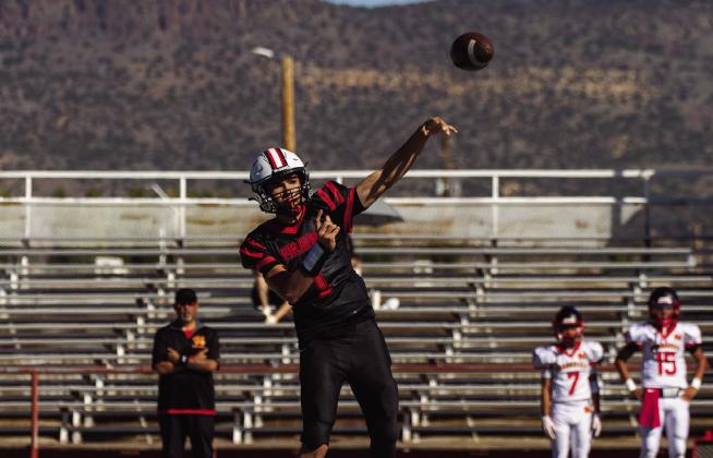 Atanacio Gallegos, freshman, throws the football during a game against Española Valley at Grants High School on Oct. 3, 2026. Gallegos extends his throwing arm as he sends the ball downfield. Jay Langford- Student Journalist