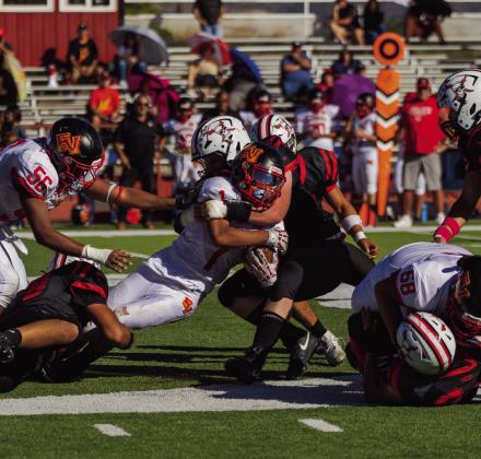 Grants High School defenders bring down an Española Valley ball carrier during a football game at Grants High School on Oct. 3, 2026. Multiple Pirates converge on the runner as he fights to maintain possession of the football. Jay Langford- Student Journalist