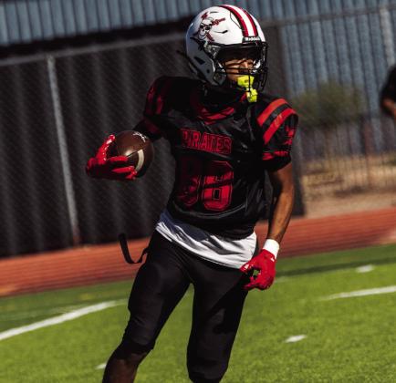 Leidyn Juanico, sophomore, carries the football downfield during a game against Española Valley at Grants High School on Oct. 3, 2026. Juanico looks ahead for approaching defenders while running along the sideline. Jay Langford- Student Journalist
