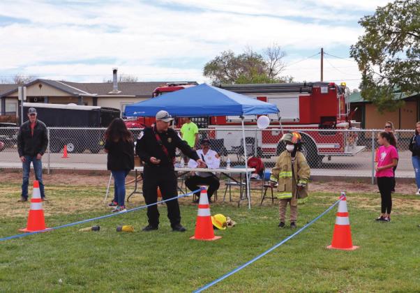 Young boy participates in firefighter obstacle