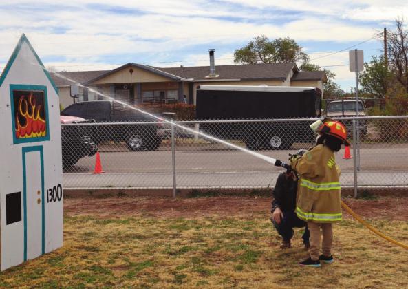 Young boy participates in firefighter obstacle