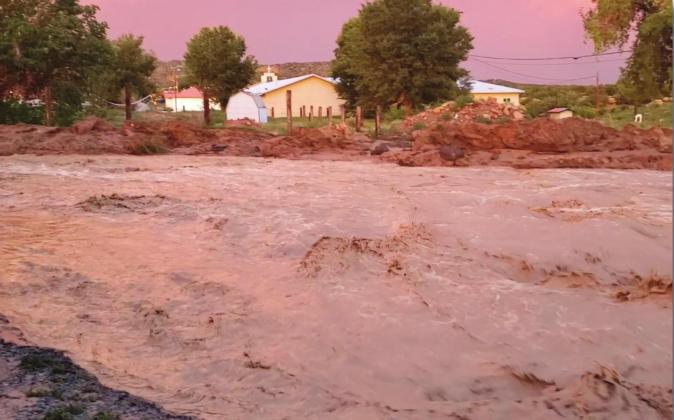 Water rushes over a county road in Cubero during a flooding event that took place last week. Two county roads, CR 7 and 8 were both washed out during the flood. Cibola County Emergency Manager Dustin Middleton said no individuals were injured and no homes were damaged. Courtesy photo