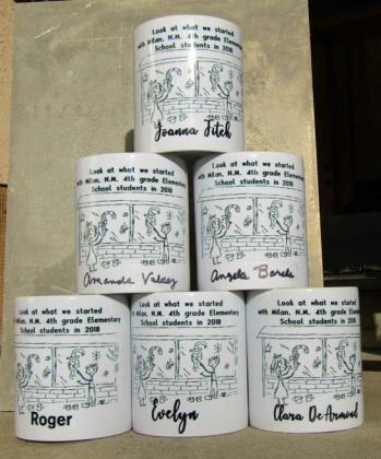 In honor of those who helped get the window painting program started in Cibola County, Roger and Evelynn Siegmann had custom coffee cups printed to honor those who helped get the program going. Courtesy Photo