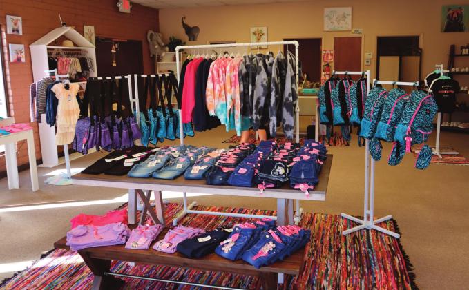 Top photo - Reyes Salazar (left) and Rita Salazar (right) stand proudly at the grand opening of Journi Jo’s Boutique, located at 201 West Santa Fe Avenue Suite A. Bottom photo - Journi Jo’s Boutique, stocked with children’s apparel, shoes, and accessories, seeks to offer something new to the Grants community with a wide selection of high-quality products. Kylie Garcia - CC