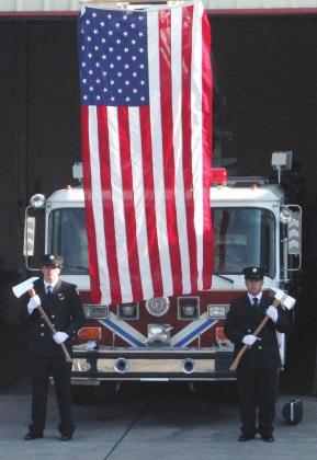 During the 9/11 open house and memorial service, the Grants Fire &amp; Rescue presented to the public a new memorial which aluminates at night (left photo) Two members of Grants Fire &amp; Rescue, (Right photo) FF/EMT Bryan Speck (left) &amp; FF/EMT Rudy C'DeBaca (right) stand at attention for the 9/11 open house and memorial service which took place Saturday at the Grants Fire Department. Scott Ford - CC
