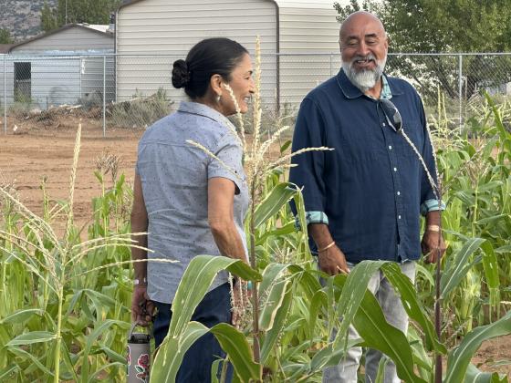Deb Haaland talks with Grants Community Pantry garden master Donald Jaramillo while touring the pantry’s Community Garden Friday morning. Jaramillo showed Haaland crops growing at the facility and discussed the garden’s development as a source of fresh produce for the pantry.