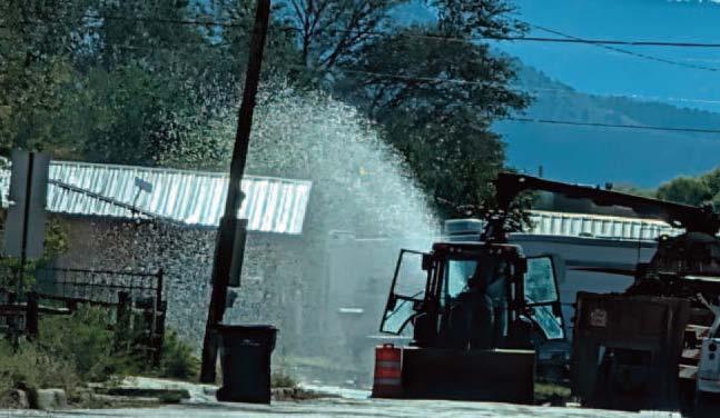 Water sprays into the air near Stephens Street in Grants on Friday, Oct. 9, following a water main break that disrupted service to surrounding properties. Repairs continued through the weekend after city crews encountered a valve encased in concrete and discovered an additional leak along a 12- inch water main.
