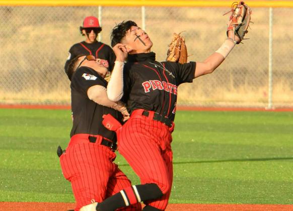 With no hole in his glove, short stop Izeyah Manzanares, 24, with a fly ball catch as third baseman Caleb McDaugle, 42, backs him up in a recent district game against the Belen Eagles. Franklin Romero - CC