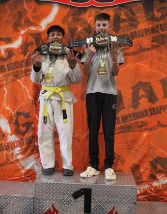 Ignacio 'Nacho' Galindo and Jo Jo Lujan pose with their 1st place trophies at a recent North American Grappling Association (N.A.G. A) tournament. 'It feels awesome,' said Joey Lujan who was their coach at the tournament and is the instructor/owner of J5's Jiu Jitsu/MMA fitness center. courtesy Photo