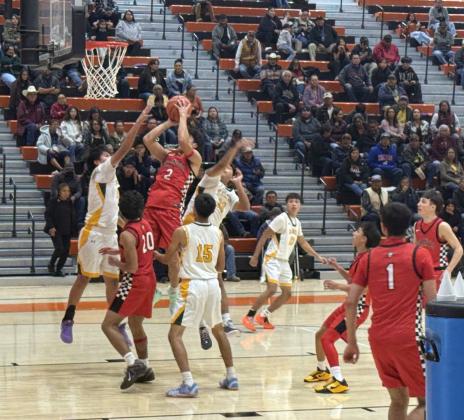 Senior Coudy Melonas, 2, with a bucket against Thoreau last Saturday at the 82nd Annual Gallup Invitational. The Pirates went 2-1 at that tournament and are currently ranked 10th in boys 4A basketball. Franklin Romero - CC