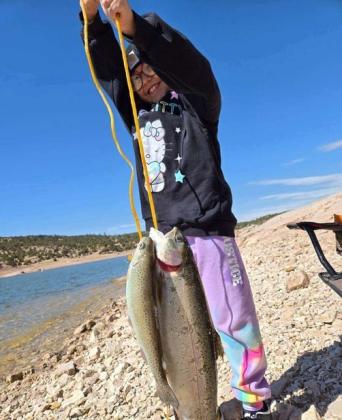 Jimmie Begay Jr. (top left ) caught five rainbow trout using Garlic PowerBait on March 9. “This was the biggest rainbow trout I’ve caught,” he said. “Bluewater Lake was some good fishing.” Serena (top right) caught her first trout using PowerBait while fishing with her grandmother, Nadine Delgarito Gordon, on March 10. Courtesy Photo
