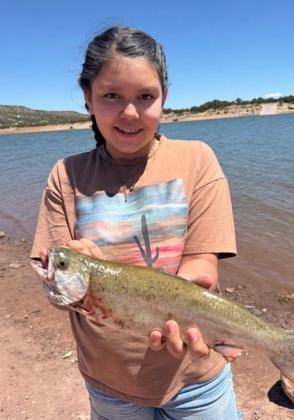 Ava G. shows off a healthy rainbow trout caught on April 24 at Bluewater Lake. She used PowerBait to land this fish during a fun afternoon of shoreline angling. Courtesy Photo