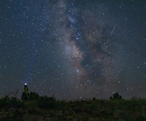 A stargazer looks toward the heart of the Milky Way at El Malpais National Monument, where pristine dark skies offer a window into the cosmos. April Astronomy Month programs invite the public to experience the wonders of the night sky with ranger-led events throughout the month. Courtesy Photo