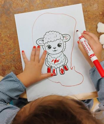 Children take part in a sheep-themed Tot and Me activity Sept. 17 at the Grants Public Library. Families listened to two sheep stories before making their own sheep using cotton and coloring materials. Courtesy Photos
