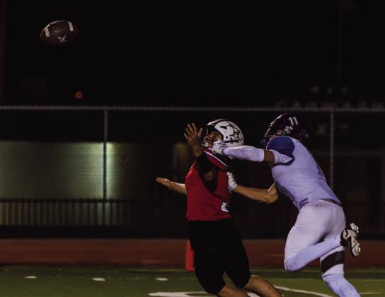Elijah Marquez, senior, reaches for a pass while being defended by a Manzano player during Grants High School’s game against Manzano on Sept. 18 at GHS. Marquez battles for position as the ball arrives. Jay Langford- Student Journalist