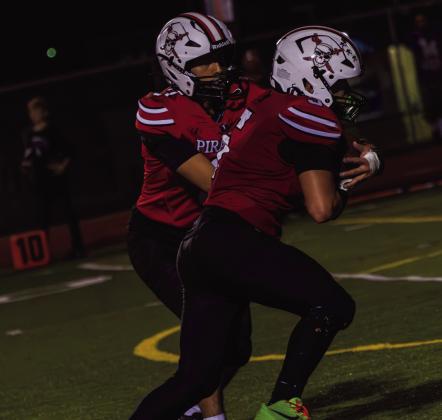 Elijah Marquez, senior, hands the ball off to Julian Fernandez, sophomore, during the Pirates’ game against Manzano on Sept. 18 at GHS. Fernandez takes the handoff as Grants looks to advance the ball. Jay Langford- Student Journalist
