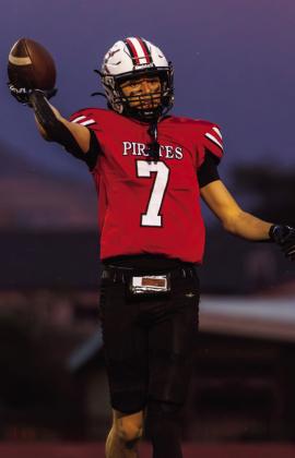 Ryan Rael, senior, holds up the football during Grants High School’s matchup against Manzano on Sept. 18 at GHS. Rael displays the ball while taking the field for the Pirates. Jay Langford- Student Journalist