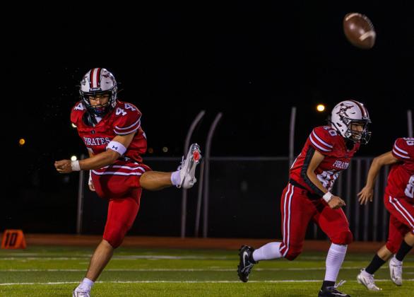Colin Lundstrum, sophomore, sends the ball downfield on a kickoff for the Pirates. Jay Langford- Student Journalist