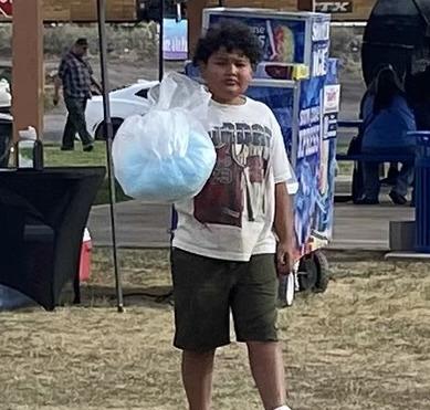 Roman Archibeque enjoys cotton candy at the Third Annual Spokes on 66 event. Photo by Martha Lopez