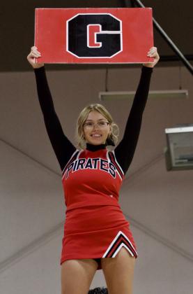 Junior Caprice Gallegos raises a Grants “G” above the crowd while performing with the cheer team during the first-day-of-school assembly on Aug. 10 at Grants High School in Grants, N.M. Jay Langford-Student Journalist