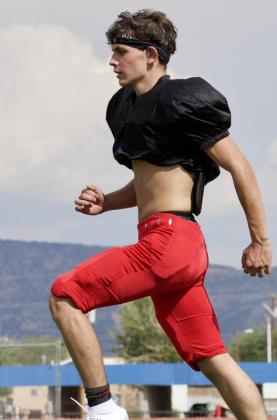 Junior receiver and punter Ernesto Martinez runs across the field during football practice on Aug. 10 at Grants High School in Grants, N.M. Jay Langford-Student Journalist