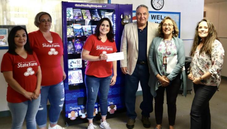 Tom Fitzsimmons State Farm employees present a donation of $500 to Mesa View Elementary to maintain the Book Work Vending Machine’s book supply. From left to right are: Mable Martinez, Amy Apodaca, Rosalia Morales, Max Perez, Jennifer Griego, and Amy Cameron. Kylie Garcia - CC