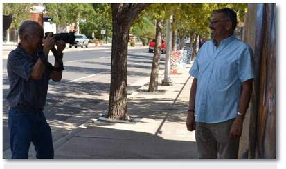 New Cibola Arts Council Director, Eric Sedillos, is inducted into the Jim Ninomiya portrait collection in front of James Emory’s new mural, as artist, Gary Yazzie, observes. Kathryn Marmon - CC