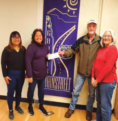 Sylvia Anzures Gonzales-CC Grants MainStreet Project, Inc. Board Member Roger Siegmann and wife Evelyn Siegmann who spearheaded the 'Christmas Window Painting Project 2021' present the check for Rotary Vice President JoAnne Martinez for the Backpack Program.