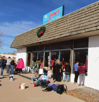 Courtesy Photo Students painted the windows at local clothing store Jenny’s in Grants, New Mexico. The holiday paint job was part of a Grants MainStreet effort spearheaded by Roger and Evelyn Siegmann. Proceeds from this event go toward the backpack program at the Rotary Club which helps feed students who are food insecure, meaning they don’t know where their next meal is coming from.