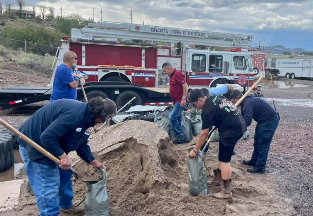 Courtesy Photo Residents in Cibola County came together to shovel dirt and sand into bags, hoping to build barriers that would prevent water from entering homes during the most recent monsoon rains. Grants Fire and Rescue, Milan Fire Department, and the Cibola Roads Department worked to get sandbags ready for residents across the county. GFR thanked residents who participated, and those who helped support their efforts, like 1912 Market on Santa Fe Avenue who took water and other snacks to the crews.