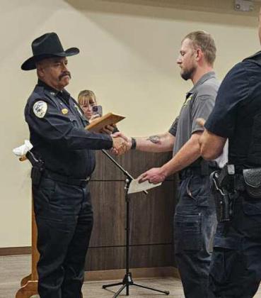 Detective Brian Gardner accepts his certificate and plaque from Sheriff Larry Diaz. Arieanna Crowson - CC