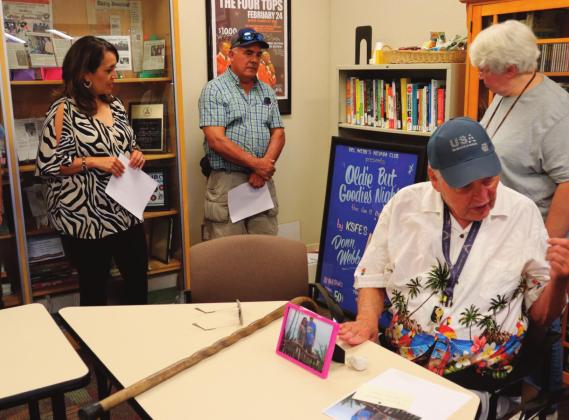 Webb shares many personal stories from his years in the radio business, discussing anything from Elvis, to The Beach Boys, to The Temptations, while NMSU faculty and friends listen intently. Below; Webb’s Special Collections exhibit, featuring rock and roll memorabilia, photographs, newspaper scraps, and academic plaques collected all throughout Webb’s life. Kylie Garcia -CC
