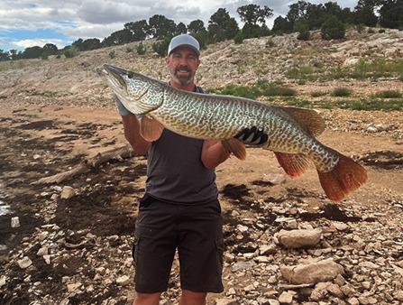 Veronica caught a near-record tiger muskie, pictured here being held by her husband, James Schaerfl, using a topwater Whopper Plopper on Aug. 16. Courtesy Photo
