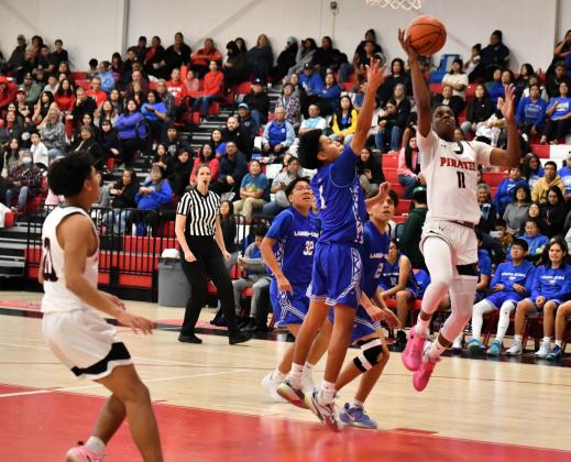 Hoop Time! Uriah Gill rakes it in for a bucket at a recent home game for the Pirates. The Pirates have lost their last two games and are currently 3-2. On December 10th they lost to St. Michaels (4-2) on the road by a score of 68-51. Most recently they lost a tight game to I-40 rival, the Gallup Bengals (3-2) in an action-packed game at the Port of the Pirates, 56-53. Franklin Romero - CC