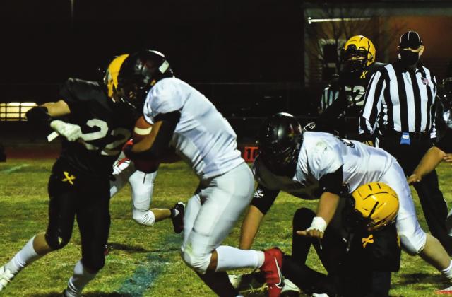 Senior running back Terrell Hocker,1, blasts a hole through the St. Pius defense at a recent away game this past Friday. The Pirates defeated the St. Pius Sartans 13-2 and are currently 1-0. They will play the Gallup Bengals this upcoming Friday,19th in Gallup (0-2). Franklin Romero. - CC