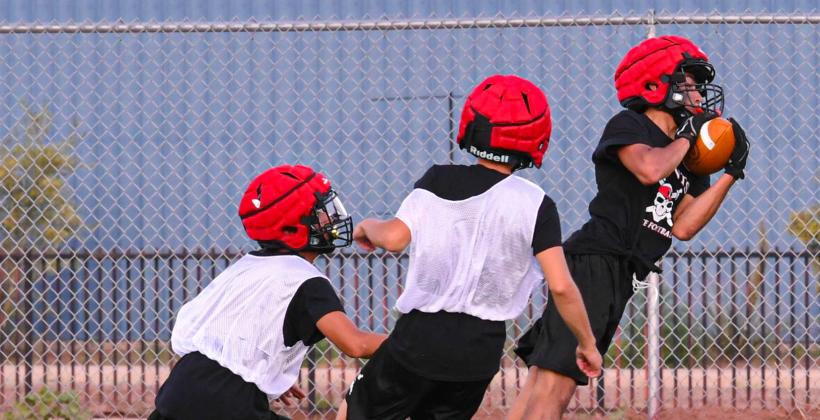 Flying Pigskins! Noah Lundstrom with a catch at a recent practice this week at the Port of the Pirates. The Pirates football team is officially practicing and are 'chomping at the bit' to start their 2024-2025. Franklin Romero - CC