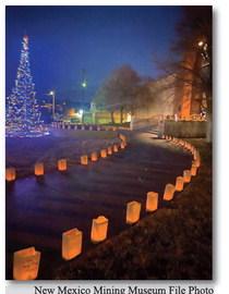 Luminarias with miner’s names on them surround the New Mexico Mining Museum on Christmas Eve December 2023.