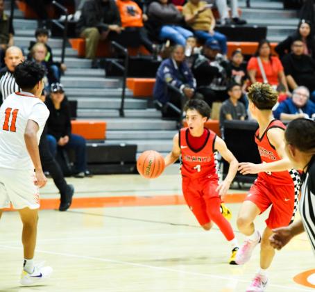 Joziah Ortega, 14, freshman point guard dribbles into the Gallup defense to run a play at a recent game in Gallup. The Pirates are 5-2 headed into the Bernalillo Tournament this weekend where they will face three 5A schools. Franklin Romero - CC