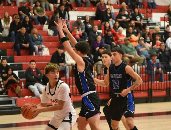 Junior guard and MVP at the Eddie Pena Holiday Classic Boudy Melonas looks for an open man as he is double teamed. The GHS Pirates went 3-0 at their home tournament and are currently 9-3. Franklin Romero - CC