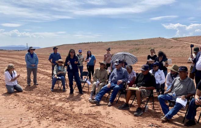 Judy Platero, secretary/treasurer of Thoreau Chapter (standing in front of second chair) tells Red Rock Landfill tour participants that the community is not opposed to the Quivira cleanup. It's opposed to bringing it to Thoreau. Photo by Kathy Helms