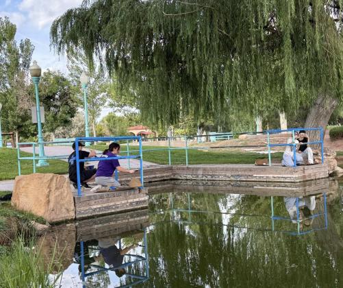 Student volunteers add fresh paint to Riverwalk railings, one of several hands-on projects transforming downtown Grants through the MainStreet program. Courtesy Photo