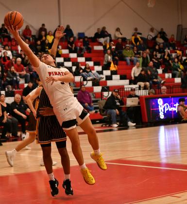 Junior point guard, Tristin Fernandez, 5, drives it in for a bucket against district rival St. Pius at a recent home game. The Pirates (12-13, 3-4) are aiming for a third place showing in the powerful 4A district 5. They are between the number one team in the state, St. Pius, and the 6th ranked team in the state, the Highland Hornets. The Lady Pirates are currently 10-15, 3-5 and both teams will play the last game of the regular season on Tuesday, February 18. Franklin Romero - CC