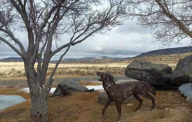 Metal coyote sculptures stand watch outside the meeting venue for the Coffee with the Managers discussions, set against the rugged backdrop of Cibola County's landscape. Inside, local leaders gather to address pressing community issues, from infrastructure improvements to legislative priorities. Diego Lopez - CC