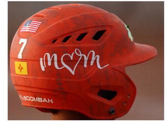 A Little League player’s orange helmet displays decals honoring his mom along with the U.S. and New Mexico flags during a game in Grants, N.M., on Thursday, July 9, 2026. Personalized gear and stickers line the helmet PHOTOS by Jay Langford, AJJ Student Jounralist