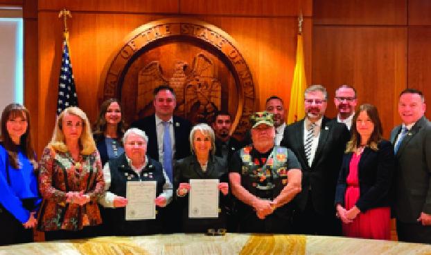 Surrounded by lawmakers, veterans, and advocates, Governor Michelle Lujan Grisham holds signed copies of House Bill 47 and House Bill 161, expanding property tax exemptions and granting free state park access to veterans. The new laws, signed on March 20, 2025, mark a significant step in honoring New Mexico’s veterans and were championed in part by the late Rep. Eliseo “Lee” Alcon. Courtesy Photo